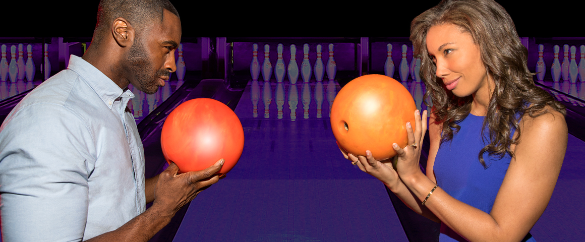 man and woman facing each other with bowling balls