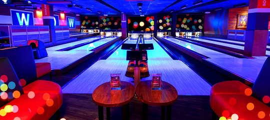 blacklight bowling lanes with glitter on the sides