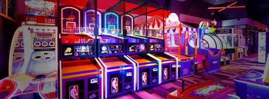 Row of Arcade Games Lit in Neon