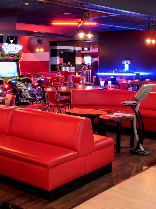 Red lounge seating with an arcade in the background