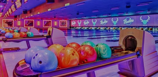 bowling balls and bowling lanes with a light pink tint