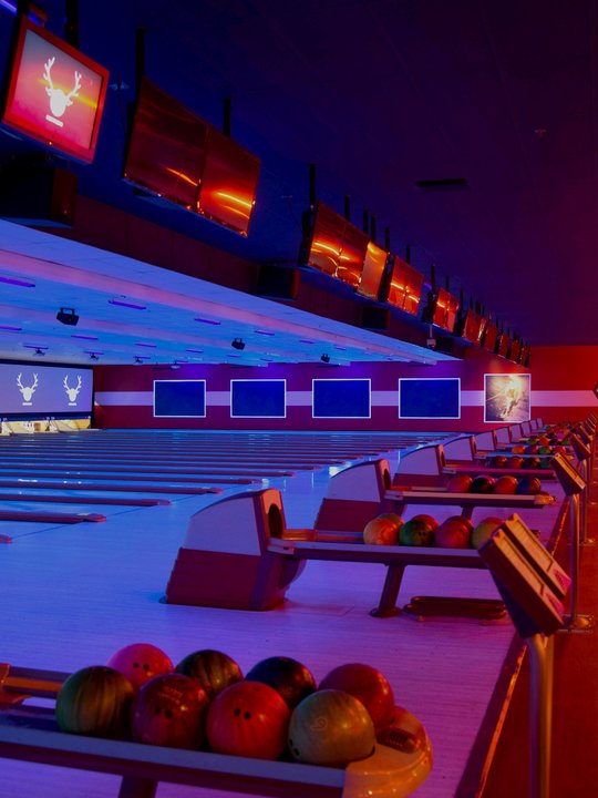 Ball return with bowling balls looking out to the lanes