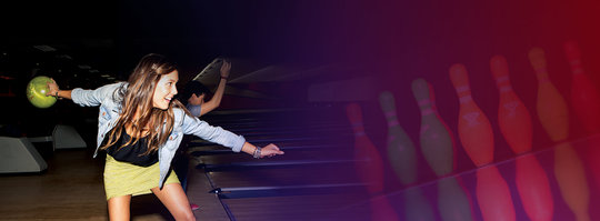 Action shot of woman bowling