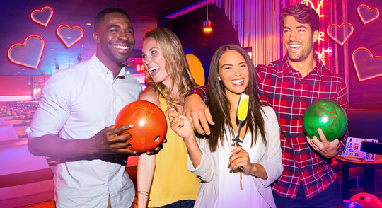 group of people holding bowling balls