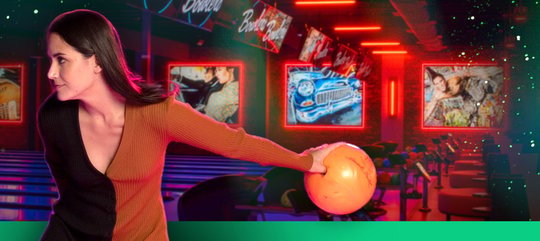 A woman throwing a bowling ball 
