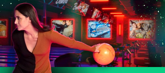 A woman throwing a bowling ball