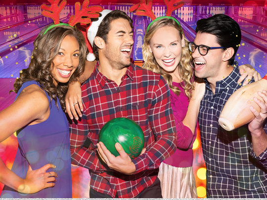 bowlers laughing in holiday attire