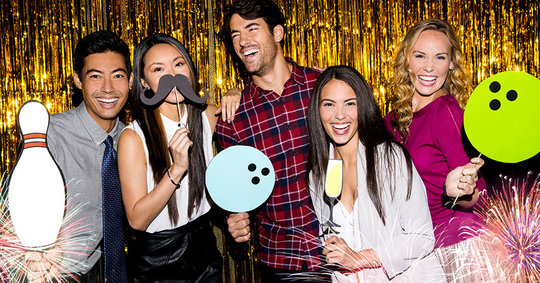 Group of people in front of gold glittery background