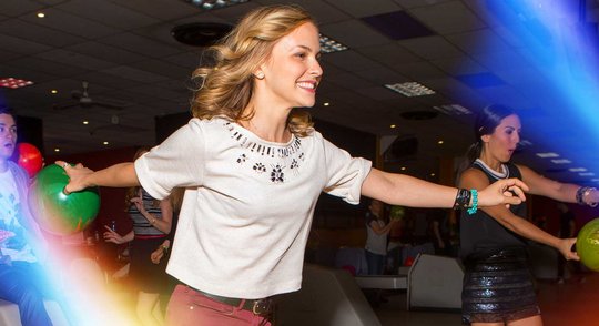 Girls throwing bowling balls