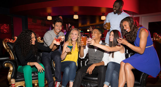 group of friends cheering a drink
