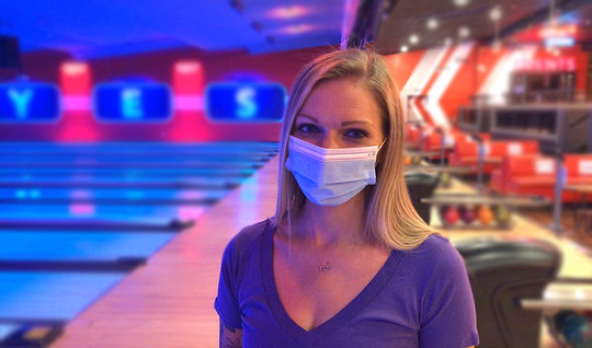 Girl wearing a mask in front of the lanes