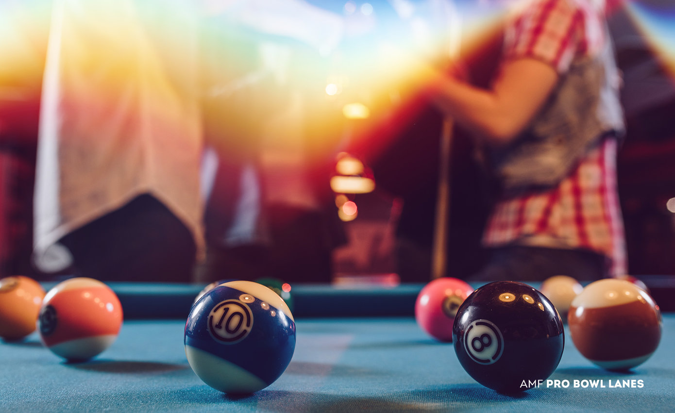 billiards table with people behind it