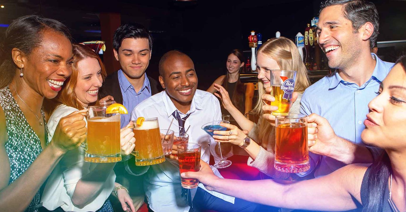 Coworkers clinking drinks together