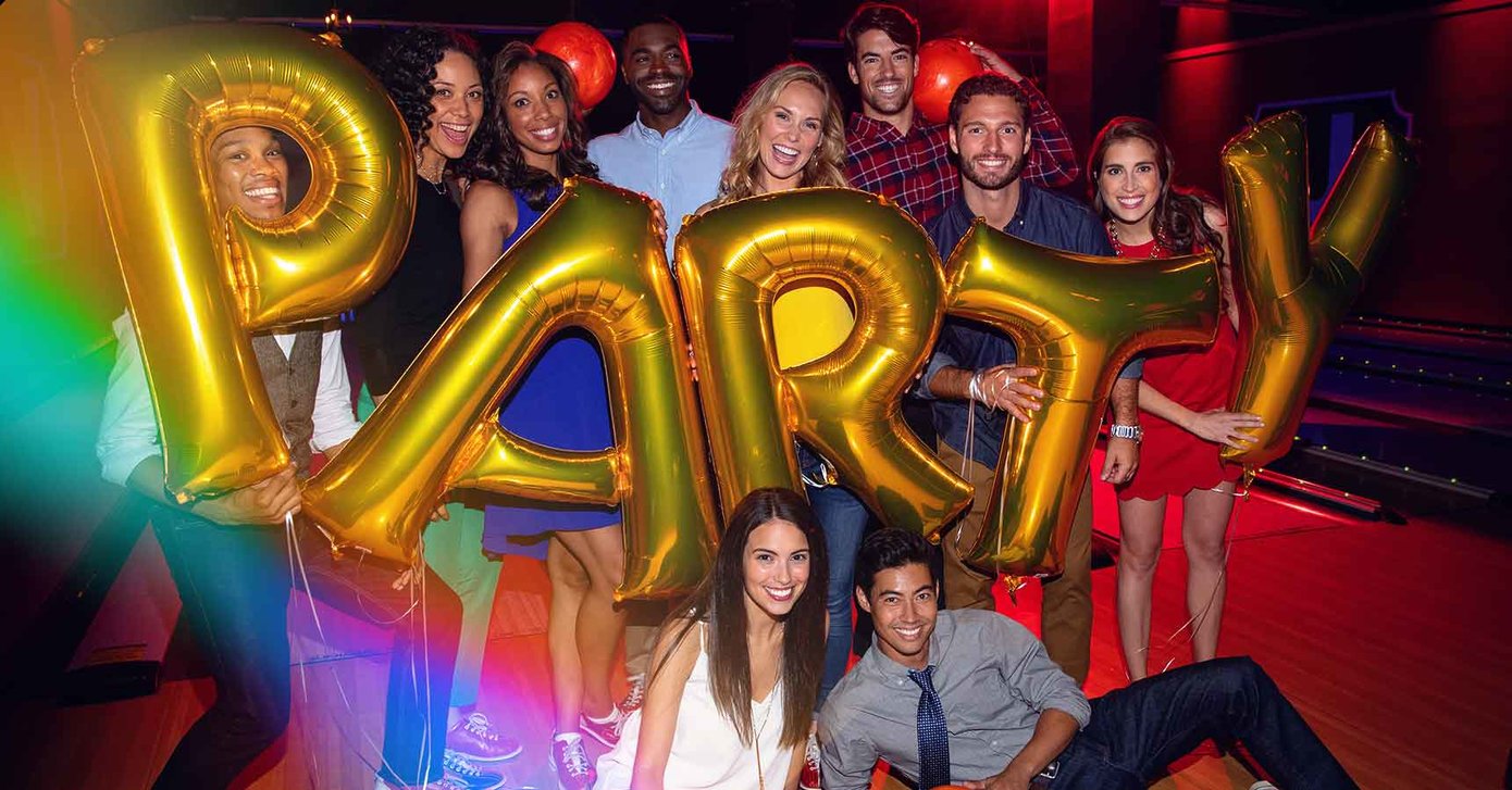 Group holding balloons spelling PARTY