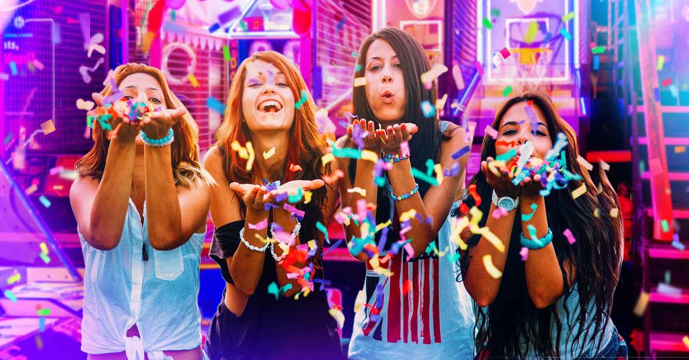 Teens in arcade throwing confetti